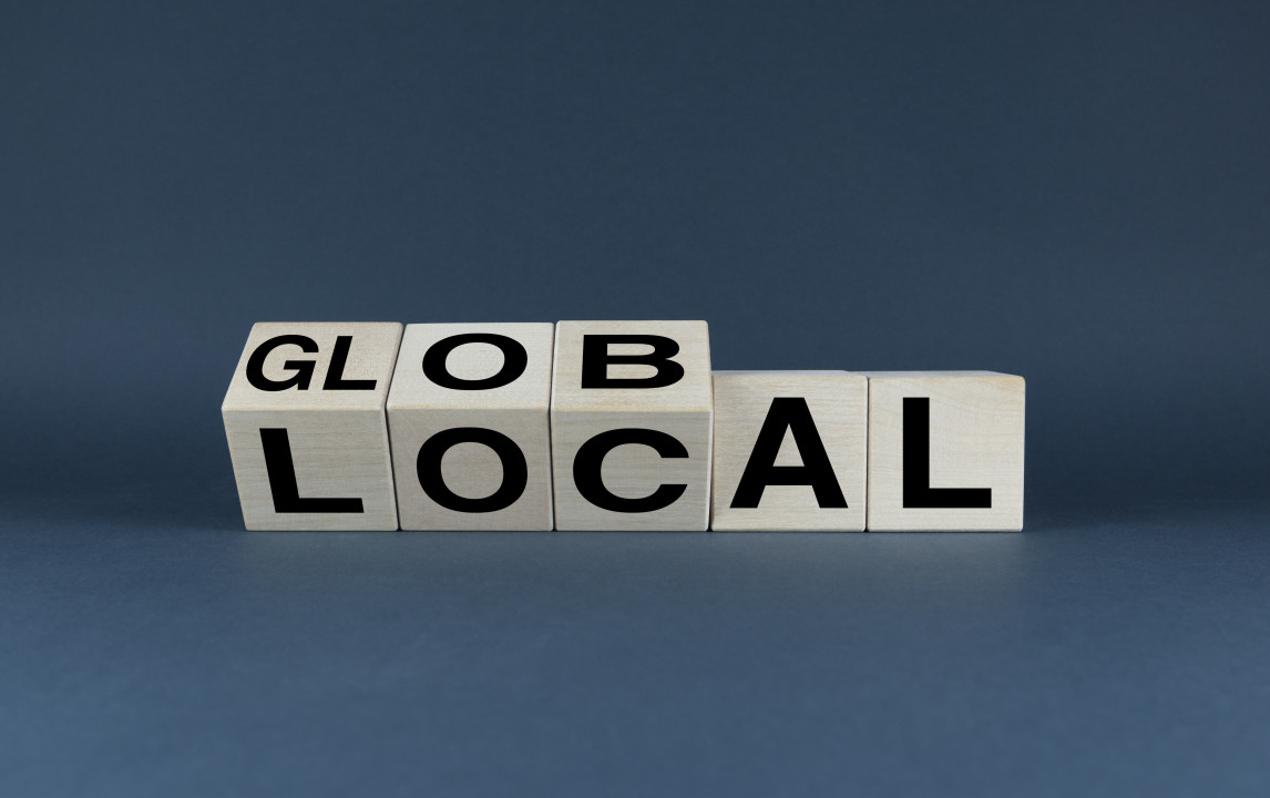 Global or Local. The cubes form the choice words Global or Local. Business Concept
