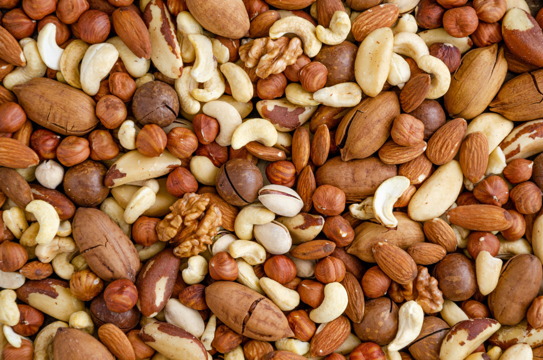 Almonds, hazelnuts, cashews, Brazilian walnut, macadamia, pecans and pistachios mixed together. Natural background. Healthy food. Top view