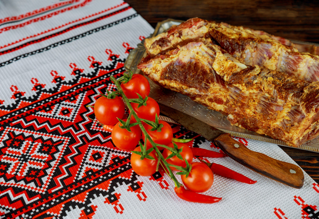 Homemade slice a piece of Ukrainian pork fat and serve on a wooden board